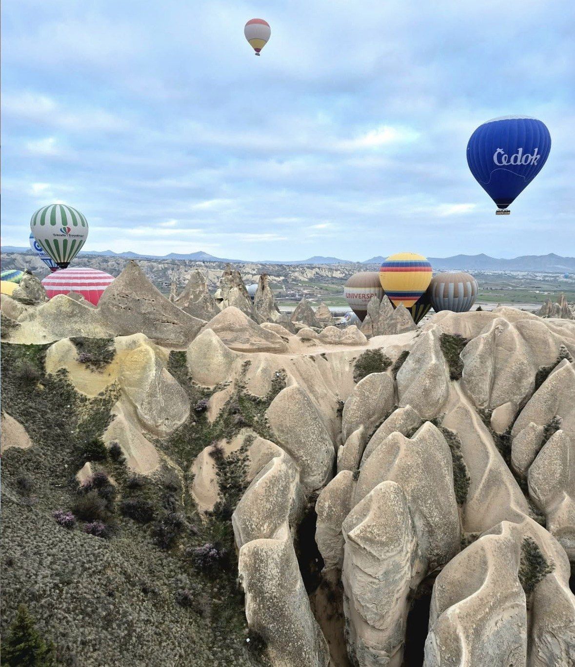 Fairy chimneys and ridged tuff rock in Cappadocia under cloudy sky